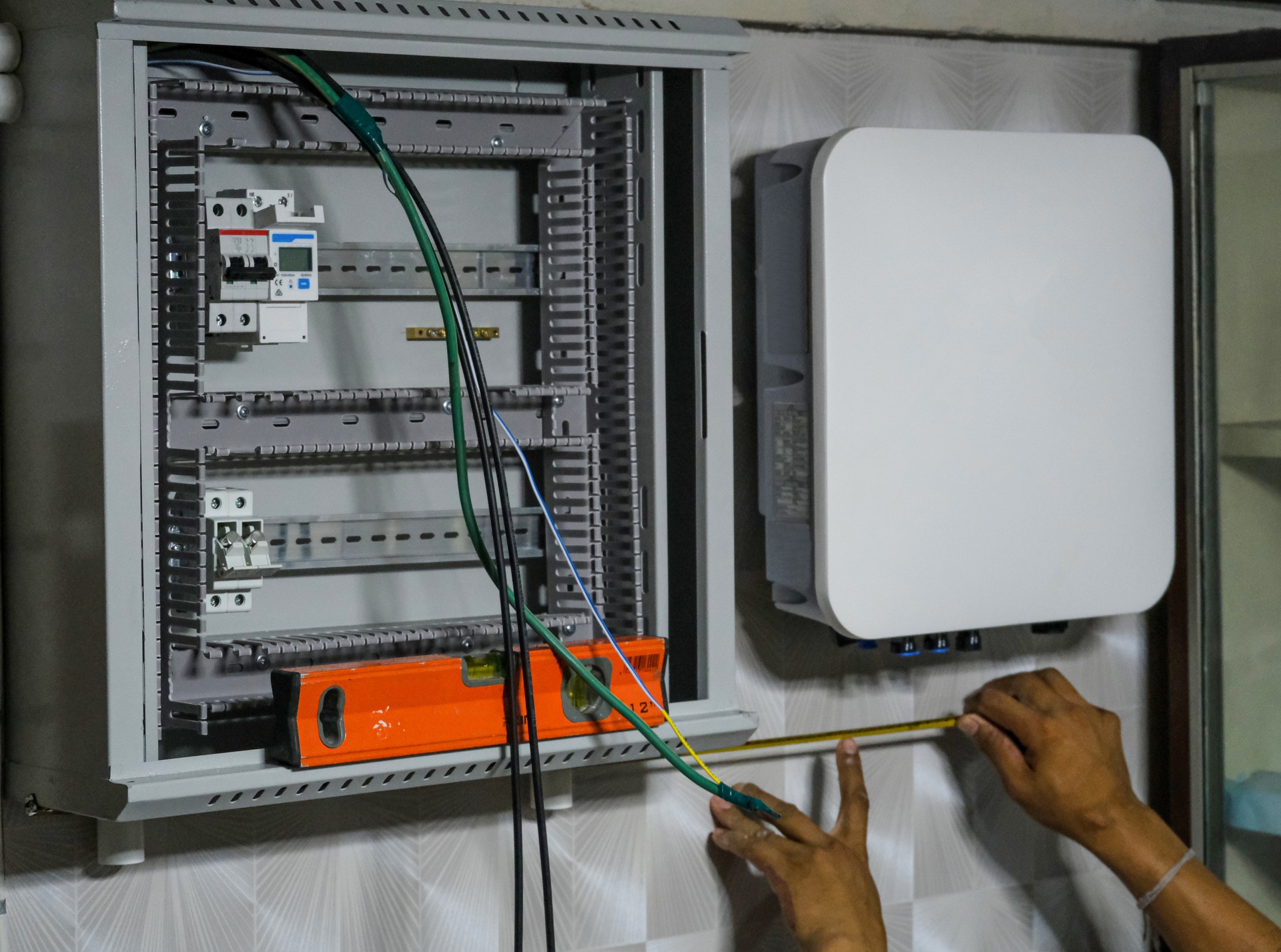 electric man install inverter panel for solar cell on wall house technician maintenance wire voltage system service for safety